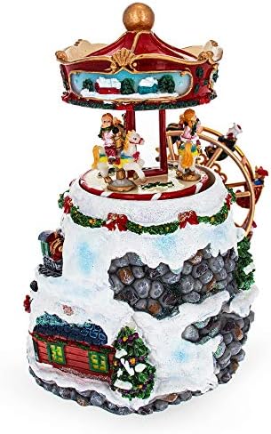 Roda girosa girada e estatueta de natal musical da vila de inverno